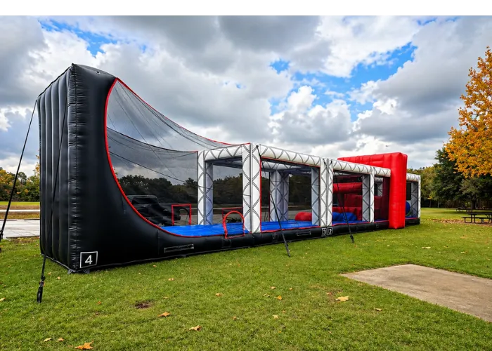 Large inflatable sports arena rental setup on grass field